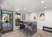 Thumbnail 7 of 24 - an open living room with a table and chairs in front of a patio door